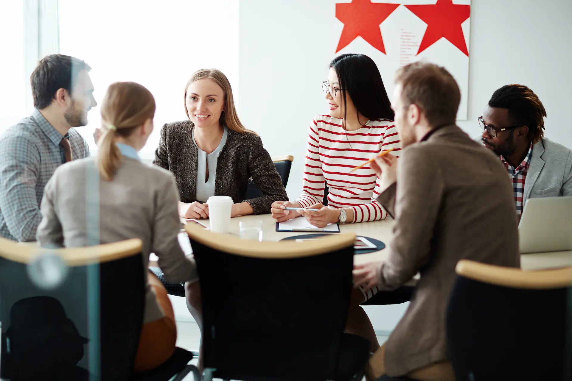 Group of people negotiating around a table